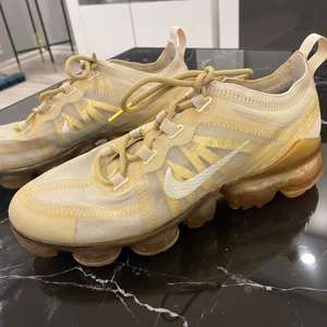 Nike Vapormax Strl 38 - Säljer dessa otroligt fräscha samt nästan nyanvända Nike Vapormax i storlek 38 från damavdelningen. Passar båda kön. De är guldfärgade och allmänt väldigt rena. Bra pris även! OBS! Möts bara upp (bor i Stockholm).