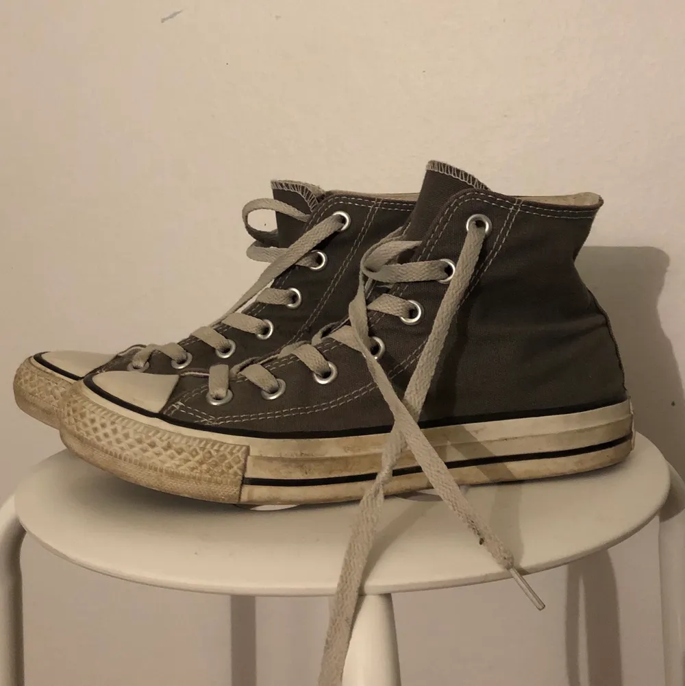 Väl-använda gråa Converse i storlek 37,5. Säljs för 150kr! En hård knut på ena skosnöret. Säljes då jag ej använder de längre. Köpare står för frakt. . Skor.