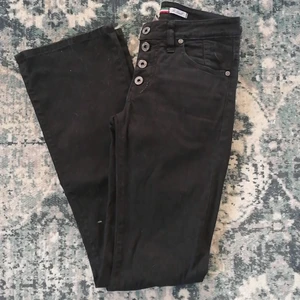 Jeans från Please strl. Xsmall - Flare jeans från det italienska märket Please, svarta, oanvända, tajta, strechjeans med ett litet silver hjärta på ena bakfickan. 