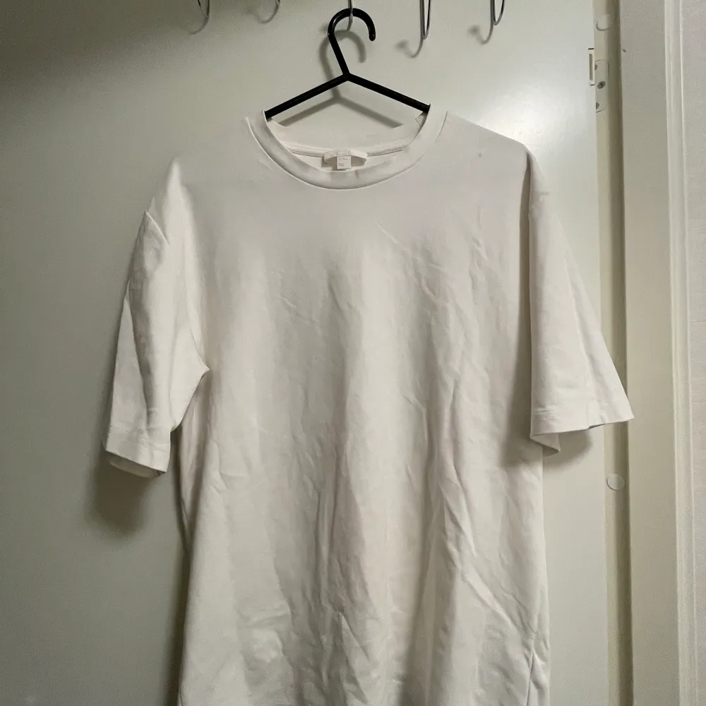 En vit t-shirt från COS i storlek XS. Lite oversize i modellen. Längre ärmar. Styvare material. . T-shirts.