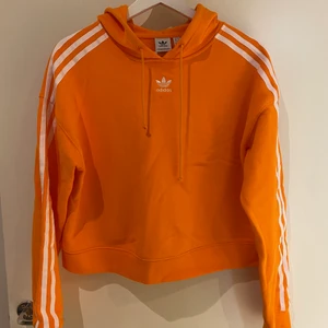 Adidas cropped orange hoodie  - Säljer min fina adidas cropped hoodie i storlek S. Fortfarande i riktigt bra skick och säljer för 250kr. kan mötas upp i Stockholm eller frakt tillkommer 📦