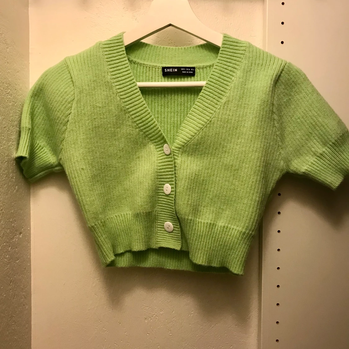 ljusgrön top med vita knappar i strl S - 90