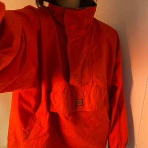 Retro vindjacka - Snygg vindjacka, perfekt för kommande vår. Färgen är lite svårtolkad, men irl är mer röd än orange. Passar egentligen alla storlekar, beroende på hur stor man gillar den. Möts upp i Lund o Malmö, kan annars posta.