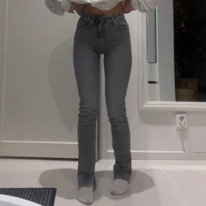 Grå jeans med slit  - Säljer mina grå jeans med slit från Zara som tyvärr inte passar mer. Storlek är 32 och jag är 165cm lång. Skriv för fler bilder <3