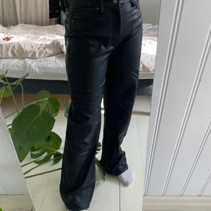 Skinnbyxor med raka ben och hög midja - Skit SNYGGA skinnbyxor i fake läder från H&M. Säljer pga att de har blivit förstora. :( Är långa i benen, perfekt längd enligt mig som är 164 cm. Dom är i fint sick förutom att de fått en slitning på höger ben, strax under knät. Men det är ingenting man tänker på. 🖤🖤