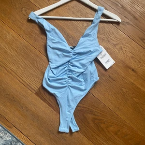 Body från Zara - Ljusblå body från Zara. Aldrig använd, prislapp kvar.