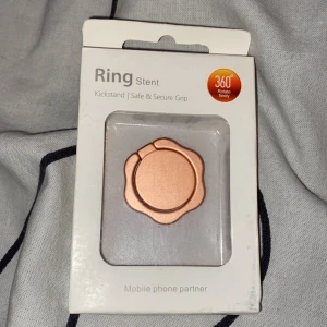 Ring stent - Ring stent som man sätter bak på mobilen eller skalet för att gå bättre grep. Den är oanvänd, säljer för 90kr +frakt! Buda om det är mer som är intresserade! 