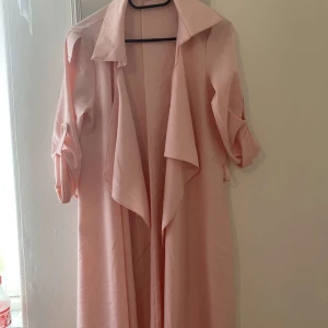 Kappa - Tunn rosa kappa. Passar perfekt till sommaren. Materialet är åt det tunna hållet. Aldrig använd så den är så gott som ny!!