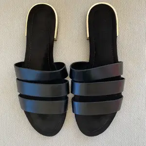 Zara TRF black leather slides. Gold detail on the heel. Size 39.  Very good condition, worn few times only.