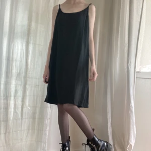 Superfin slip dress - Svart slip dress. Storlek L men jag på bilden har XS så den passar olika beroende på hur man vill att den ska sitta