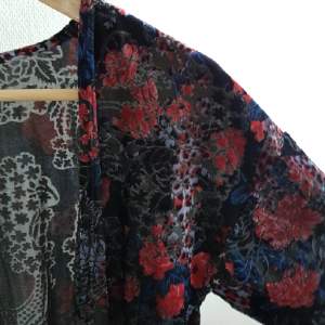 Kort, mönstrad kimono med sammetsapplikationer och fransar nedtill. Storlek S/M. Från Topshop.