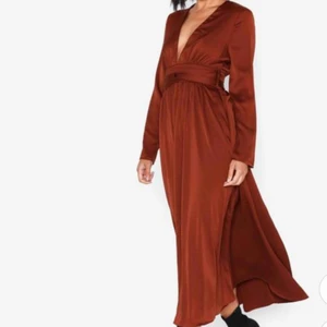  - Fantastiskt smickrande satinklänning i kopparrött, med markerad midja och knytband. Aldrig använd. Nypris: 729kr 