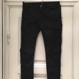  - Säljer svarta byxor med fickor på benen. Från Monki, storlek M.