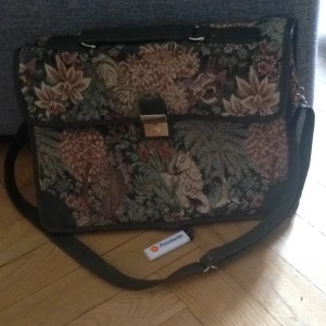  - Portfölj. Vintage. Blommigt tyg med fakeskinn och gulddetaljer. 