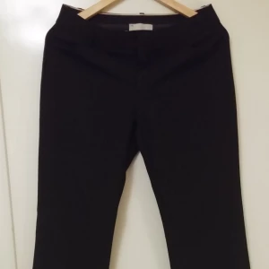  - Black pants. Gap "Curvy" fit, which feels and looks great! I don't wear these anymore because I have a smaller size now. They are size 4 regular (like a 40). Mid waist.  They have two small pockets on the sides. 