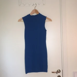  - Kort, tight klänning i strl 36. Endast använd en gång. Lite mer åt det klarblå hållet i verkligheten