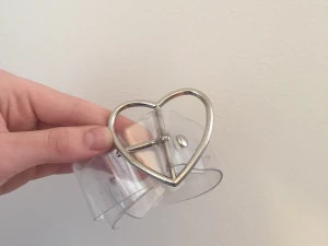 Genomskinligt skärp med hjärt buckel - Genomskinligt skärp med silvrig hjärt buckel. Har gjort ett eget hål i den. Skriv i kommentarerna ifall ni har frågor om längd osv