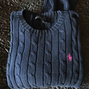  - Stickad tröja från Ralph Lauren i strl S. Mörkblå med rosa märke. Lappen i nacken är trasig (se bild 1) men det är den enda defekten :)