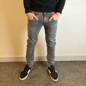 Replay anbass jeans - Gråa replay anbass jeans. Storleken är 32/32 men sitter mer som 31/32. Modell på bild är 186 cm 72kg.