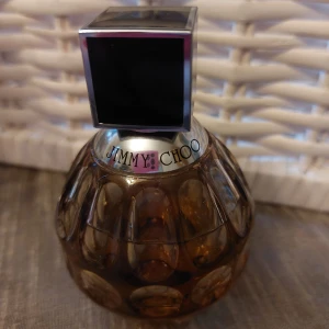 Parfym från Jimmy Choo - Från Jimmy choo:s hemsida : "Det som karaktäriserar Jimmy Choo kvinnan är att det är en urban och trendig kvinna med en stark personlighet. Doften är synonym med femininitet, lyx och stil. En doft som representerar den ultimata kvinnliga accessoaren. Toppnot: Gröna noter Hjärtnot: Tiger orchidé, Teros, Päron, Ingefära Basnot: Cederträ" 