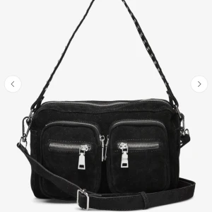 Svart noella väska  - Snygg svart axelväska i mocka med två framfickor och dragkedjor. Väskan är ifrån märket noealla. Säljer för att den inte kommer till andvändning. Pris går att diskutera. Snabbt köp=lägre pris. Skriv gärna för flera bilder 💗