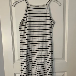 Randig klänning från Zara - Säljer en superfin randig klänning från Zara i svart och vit. Den är ärmlös och perfekt för sommardagar. Klänningen har en enkel och stilren design med smala axelband. Passar både till stranden och en dag på stan. 🖤🤍