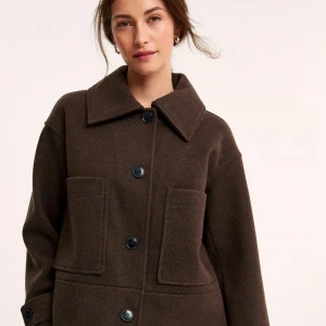 Brun kappa från Kappahl  - Snygg brun kappa från Kappahl med stora knappar och två framfickor. Jackan har en klassisk krage och långa ärmar. Perfekt för höst och vår! Säljer den just därför, jag har ingen användning av den. Säljer den för 350+frakt nypris 899kr. 