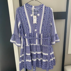Blå och vit klänning med mönster - Super snygg klänning med fina mönster!🤩💙Den är helt oanvänd med prislappen kvar, köptes för 399 kr.💞Meddela mig för mer info🌸💕