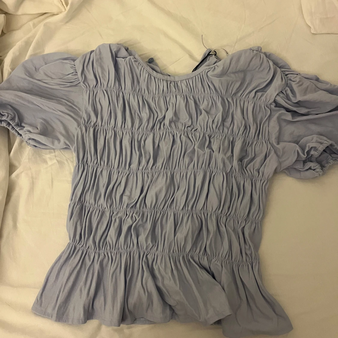 Ljusblå blus med puffärmar