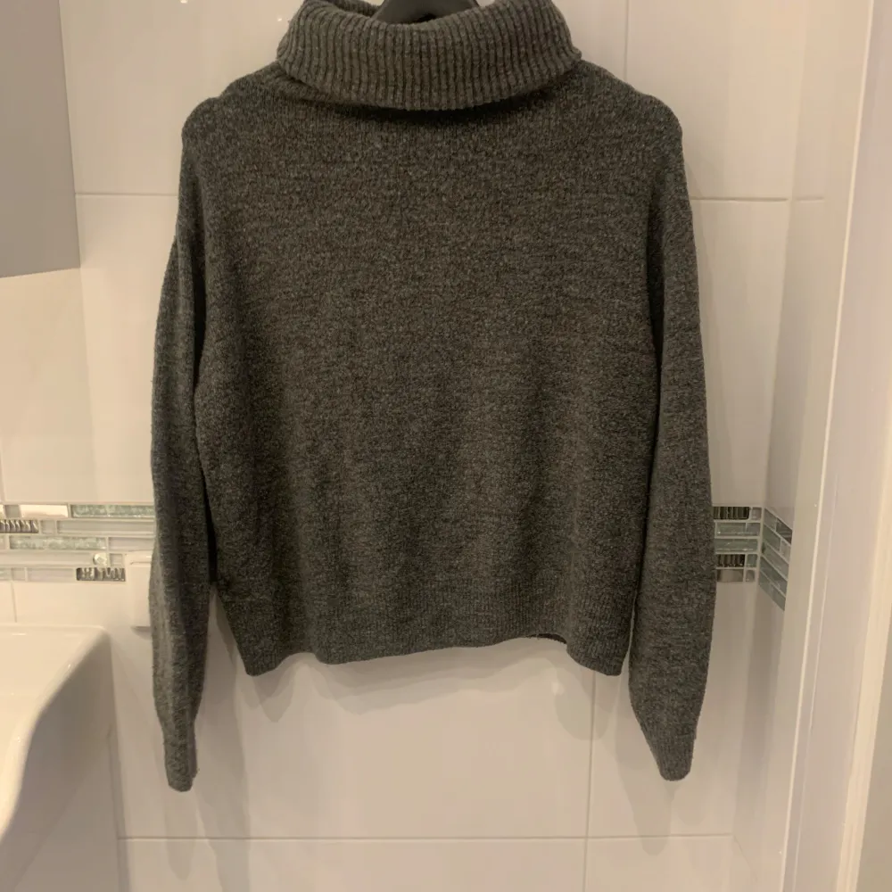Mysig grå stickad polotröja från H&M. Perfekt för kyliga dagar med sin höga krage och långa ärmar. Enkel och stilren design som passar till det mesta.. Neuletakit & Villapaidat.