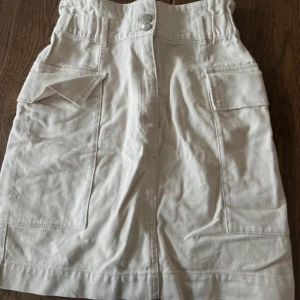 Beige Cargo Kjol - Snyggaste cargokjolen du kan hitta. Sitter tajt och högt i midjan. Superfin och säljes pga den är för liten efter graviditet.