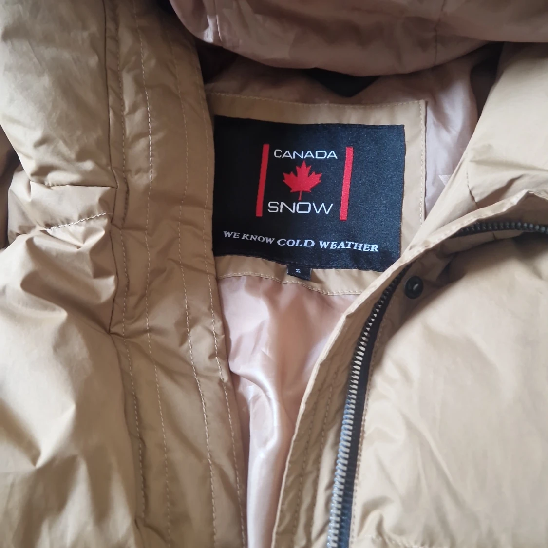 Brun lång dunjacka från Canada Snow - 90
