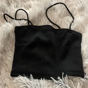 Svart ribbad tubtopp från Gina Tricot - Säljer en svart ribbad tubtopp från Gina Tricot i storlek XS. 
