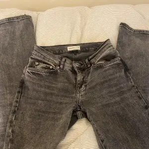 Säljer ett par snygga grå/svarta jeans från Gina Tricot. Dom är lowwaist bootcut. Dom är i bra skick och är i storlek 32. Nypris 499