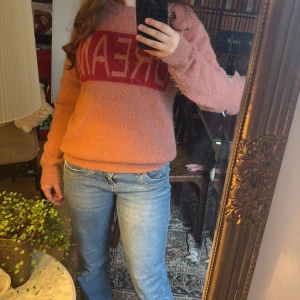 Rosa tröja med text, från SOFIE SCHNOOR - Säljer en mysig rosa tröja med texten 'DREAM' i rött framtill. Den är gjord i ett mjukt material som känns skönt mot huden och tröjan håller en varm!!💕