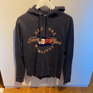Tommy Hilfiger Hoodie - Köpt för ett fler antal år sedan och har stått i garderoben i lika många så det är dags att sälja den Ord runt 1500kr.  Håller på spara till studenresa så vill få bort dem så snabbt som möjligt pris kan diskuteras.