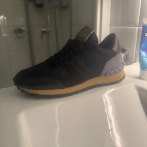 Svarta sneakers från Valentino - Feta Valentino rockrunners, i färg Svart. Riktigt unik o snygg design. Dom är helt nya och är i nypris 7800. Pris kan diskuteras men kom inte med låga bud och slösa tid. Box inklusive alla saker kommer med.!.