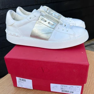Open sneakers från Valentino - Sneakers från Valentino med silverkant. Strl 36, innersulans mått 24,2cm. Original skokartong ingår. Väl använda men fräscha, rengjorda, putsade med skokräm, nya skosnören (Valentino) - se slitage på närbilder - supersnygga! Zooma för att se defekter/slitage. Skicka dm för fler bilder 🤍