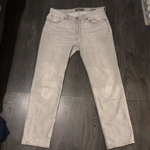 gråa jeans - gråa jeans från Dressmann. de är regular fit och är i storlek 34-32. liten deffekt på högra bakfickan men syns knappast när de är på. Original pris 600