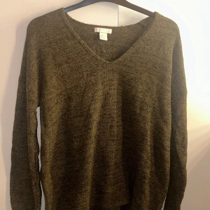Stickad tröja  - Mörkgrön tröja. Stickad. V-ringad.
