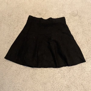 Svart kjol från XOXO friends - Snygg svart kjol från XOXO friends i en klassisk design. Perfekt för att matcha med olika toppar och accessoarer. Kjolen har en enkel och stilren look som passar till många tillfällen.