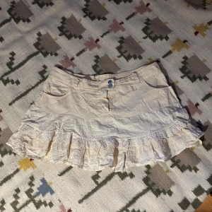 Söt kjol - Söt kort kjol med volang i krämvit färg 💗 finns en liten fläck på kjolen som inte är särskilt synlig, se bilder