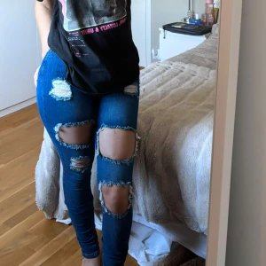 Slitna jeans - Högmidjade slitna jeans i storlek 1, vilket motsvarar xs. Dem är från fashionnova och i superfint skick. 