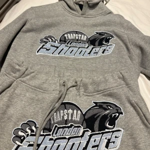 Grå tracksuit från Trapstar - Säljer en grå Tracksuit från Trapstar ”London shooters” edition svår att få tag i, självklart äkta