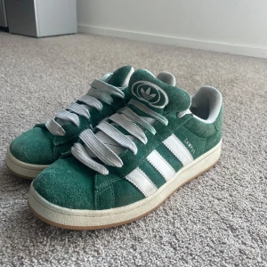 Gröna Adidas Campus sneakers - Säljer ett par gröna Adidas Campus sneakers. Mycket bra skick, köpta i mars men inte använda så ofta och därför jag säljer. Köpte på footlocker för 1400 och säljer för 599! Skriv vid frågor