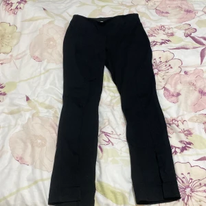 Svarta byxor med slits - Snygga svarta byxor med slits vid anklarna. Perfekta för en stilren look. De har en tight passform och är tillverkade i ett bekvämt material. Sitter mycket bra på kroppen!