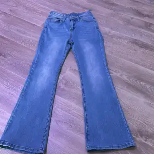 Säljer ett par snygga blå bootcut jeans.  har en klassisk femficksdesign med två bakfickor som har knappar. Jeansen är i bra skick och perfekta för både vardag och fest. Passar till alla tillfällen och är superbekväma att ha på sig. Köp dem nu och uppgradera din garderob! 💙