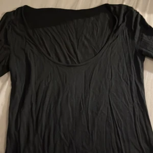 Svart långärmad topp - Säljer en enkel och stilren svart topp med långa ärmar. Perfekt basplagg för garderoben. Toppen har en rund halsringning och är tillverkad i ett mjukt material.