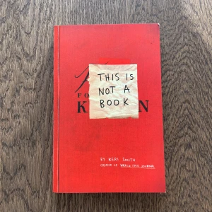 This Is Not a Book - Upptäck 'This Is Not a Book' av Keri Smith, skaparen av 'Wreck This Journal'. Denna kreativa bok utmanar dig att tänka utanför boxen med interaktiva uppgifter och uppmaningar. Perfekt för den som älskar att utforska sin fantasi och kreativitet. Boken är i en djärv röd färg med en unik design.