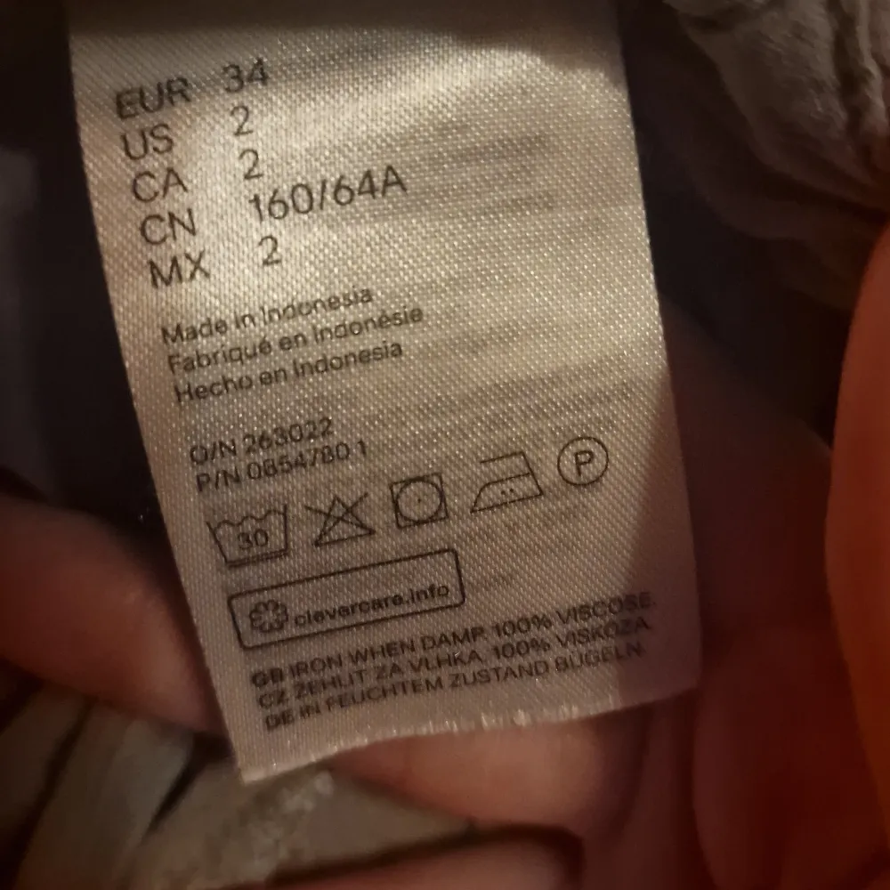 Säljer ett par grå byxor från H&M Divided. De är i storlek 34 (dam XS) och tillverkade av 100% viskos, vilket gör dem superbekväma och lätta. Byxorna har en avslappnad passform med knytband i midjan för en justerbar passform. Perfekta för en chill dag eller en avslappnad utflykt!. Farkut & Housut.